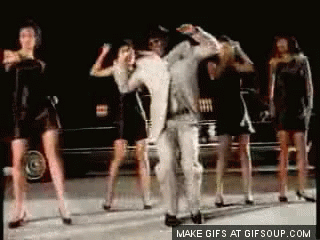 Group of Women Dancing With Man in White Suit