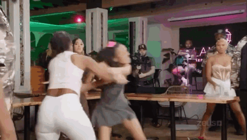 Group Of Women Fighting While Man Stands Behind GIF