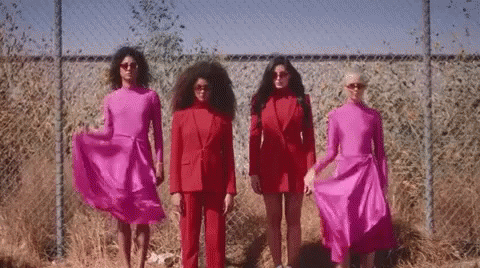 Group of Women in Red by Chain Link Fence