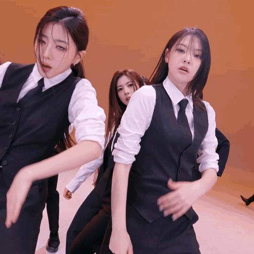 Group of Women in Suits and Ties Dancing on Stage