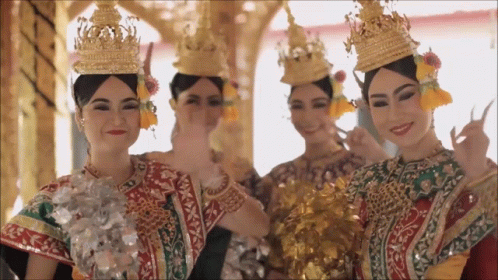 Group Of Women In Traditional Costume And Crowns GIF