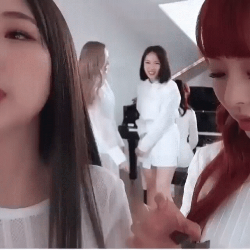 Group of Women Standing in Front of Piano