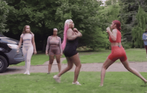 Group Of Women Standing In Grassy Area With Car GIF