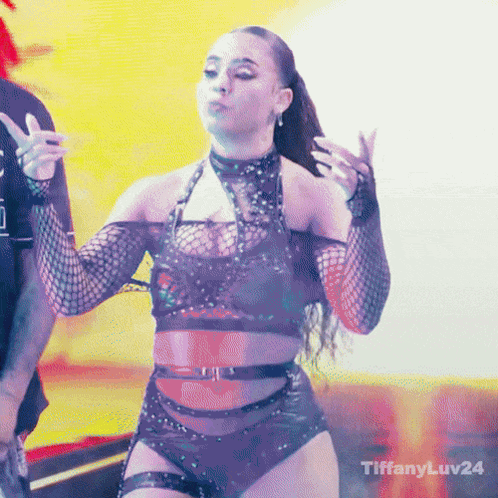 Group of Women Standing on Stage in Dark Room