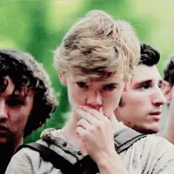 Group Of Young Men Covering Mouths Standing Together GIF