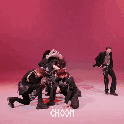 Group of Young Men Dancing in Front of Red Background Choom