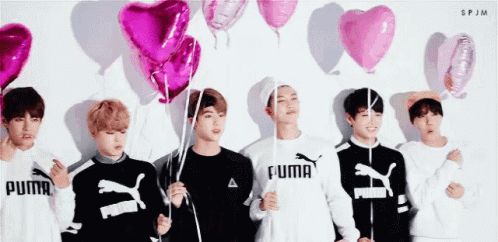 Group of Young Men Holding Pink Balloons