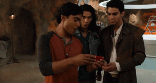 Group of Young Men Looking at Cell Phone