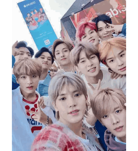 Group of Young Men Posing in Front of Music Sign