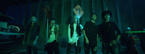 Group of Young Men Standing in Front of Cross Sign