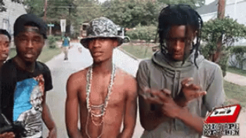 Group Of Young Men Standing On Street GIF