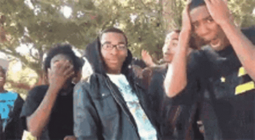 Group Of Young People Covering Faces GIF