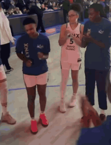 Group On Basketball Court Wearing Mayo Clinic Shirt GIF