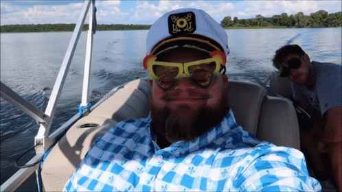 Group on Boat Holding American Flag and Sign Me Up Sign