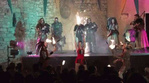 Group on Stage Woman Holding Torch