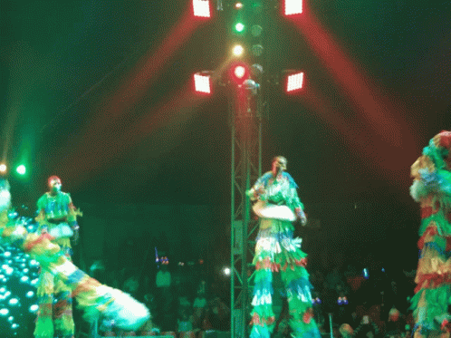 Group on Stilts Dancing in Front of Crowd