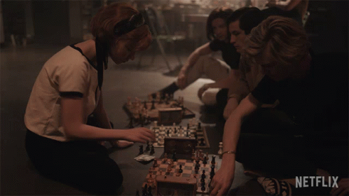 Group Playing Chess With Netflix Logo GIF