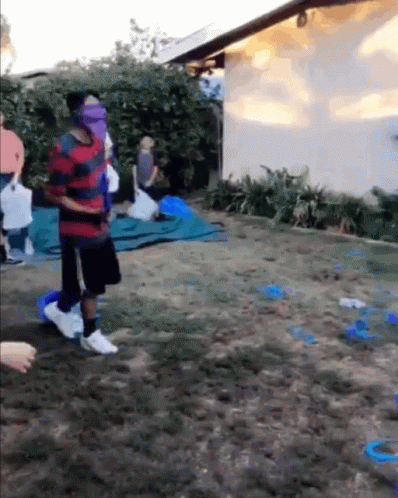 Group Playing Game In Backyard With Blindfolded Man GIF