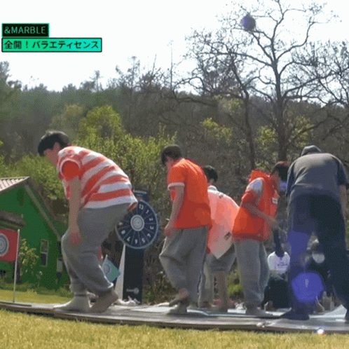 Group Playing Game With Green Sign Saying Marble