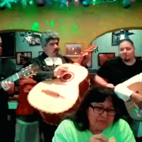 Group Playing Guitars Under Green Lights