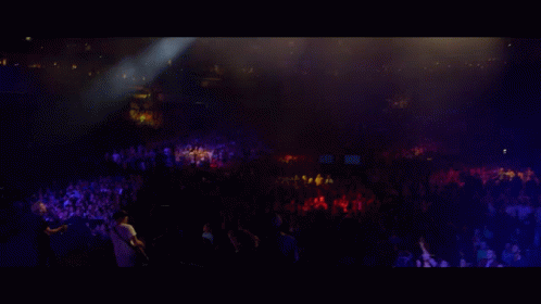 Group Playing Instruments on Stage With Large Screen Behind