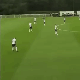 Group Playing Soccer on Green Field