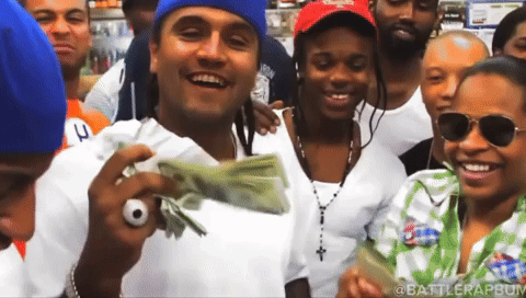 Group Posing With Stack of Money