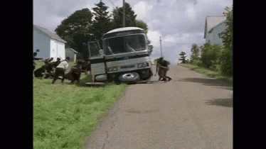 Group Pushing Bus Crashed Into Grassy Hill