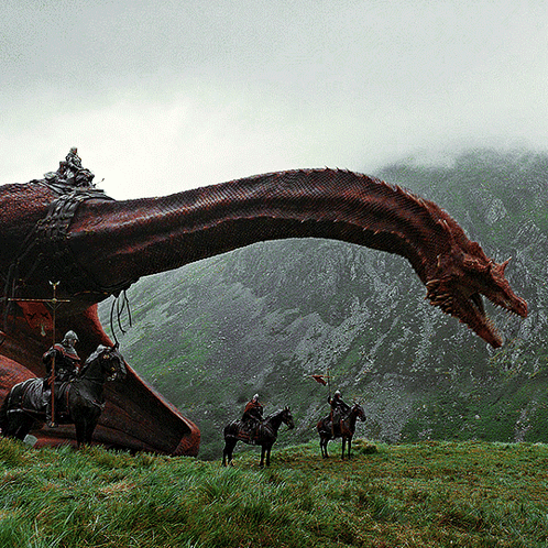 Group Riding Horses In Front Of Red Dragon GIF