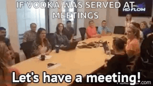 Group Sitting Around Conference Table With Laptop