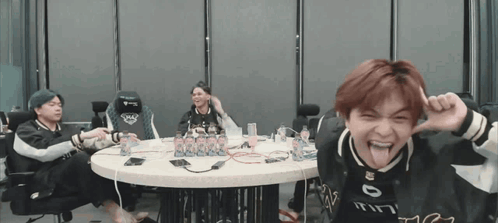 Group Sitting Around Table One Sticking Out Tongue GIF