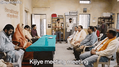 Group Sitting Around Table Saying Kijiye Meeting Meeting