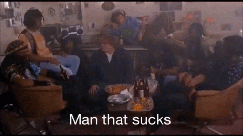 Group Sitting Around Table Saying Man That Sucks