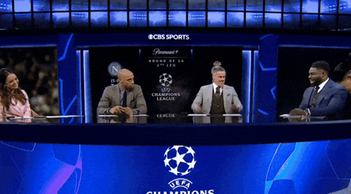 Group Sitting at Champions League Logo