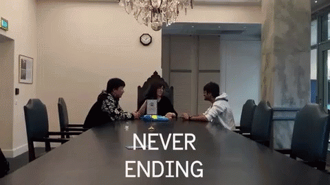 Group Sitting at Table Saying Never Ending