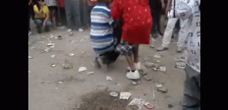 Group Sitting In Front Of Flower-Covered Coffin GIF