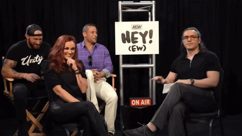 Group Sitting in Front of Hey (Ew) Sign