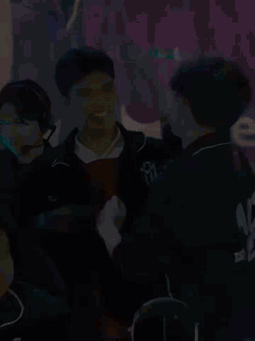 Group Sitting In Front Of Sign Saying We GIF