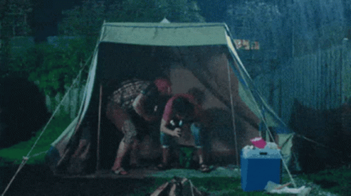 Group Sitting In Tent With Blue Cooler GIF