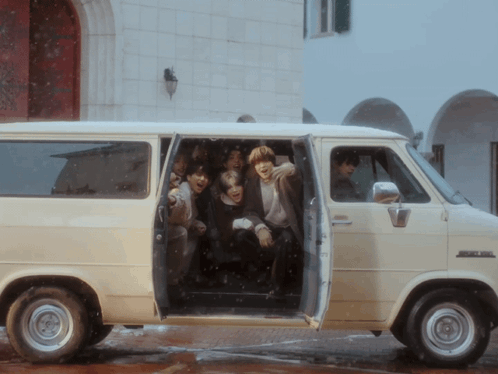 Group Sitting in Van With Doors Open