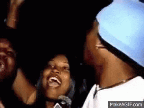 Group Standing Around Man In Blue Hat Smiling GIF
