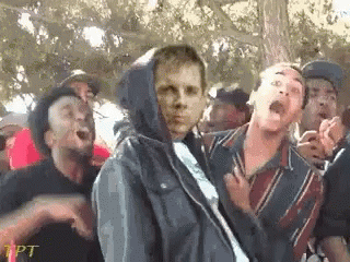 Group Standing Around Man in Hoodie