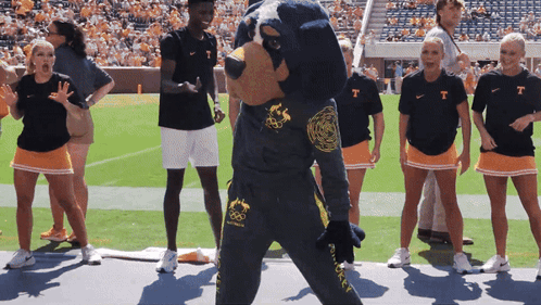 Group Standing Around Mascot in T-Shirt