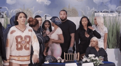 Group Standing Around Table With Jersey Number 83 GIF
