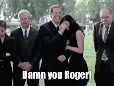 Group Standing in Cemetery Damn You Roger