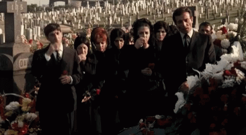 Group Standing In Circle Holding Roses In Front Of Tree GIF
