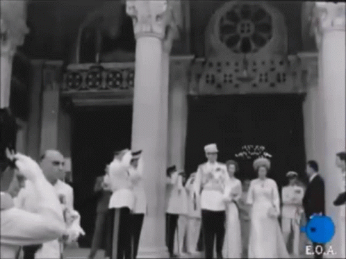 Group Standing In Front Of Building With E.O.A GIF