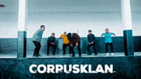 Group Standing In Front Of CorpusKlan Sign GIF