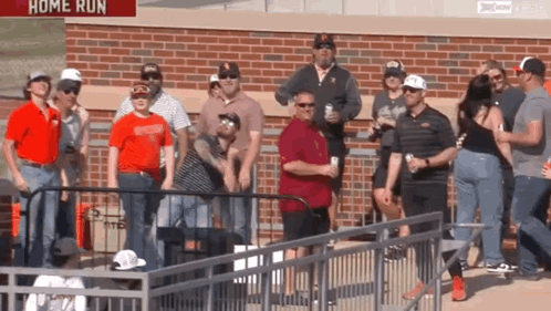 Group Standing In Front Of Home Run Sign GIF
