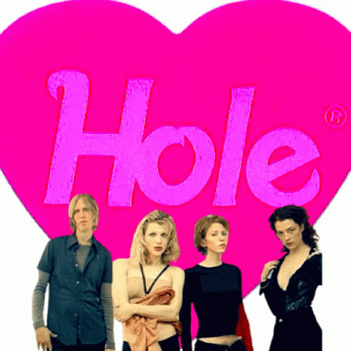 Group Standing In Front Of Pink Heart Saying Hole GIF